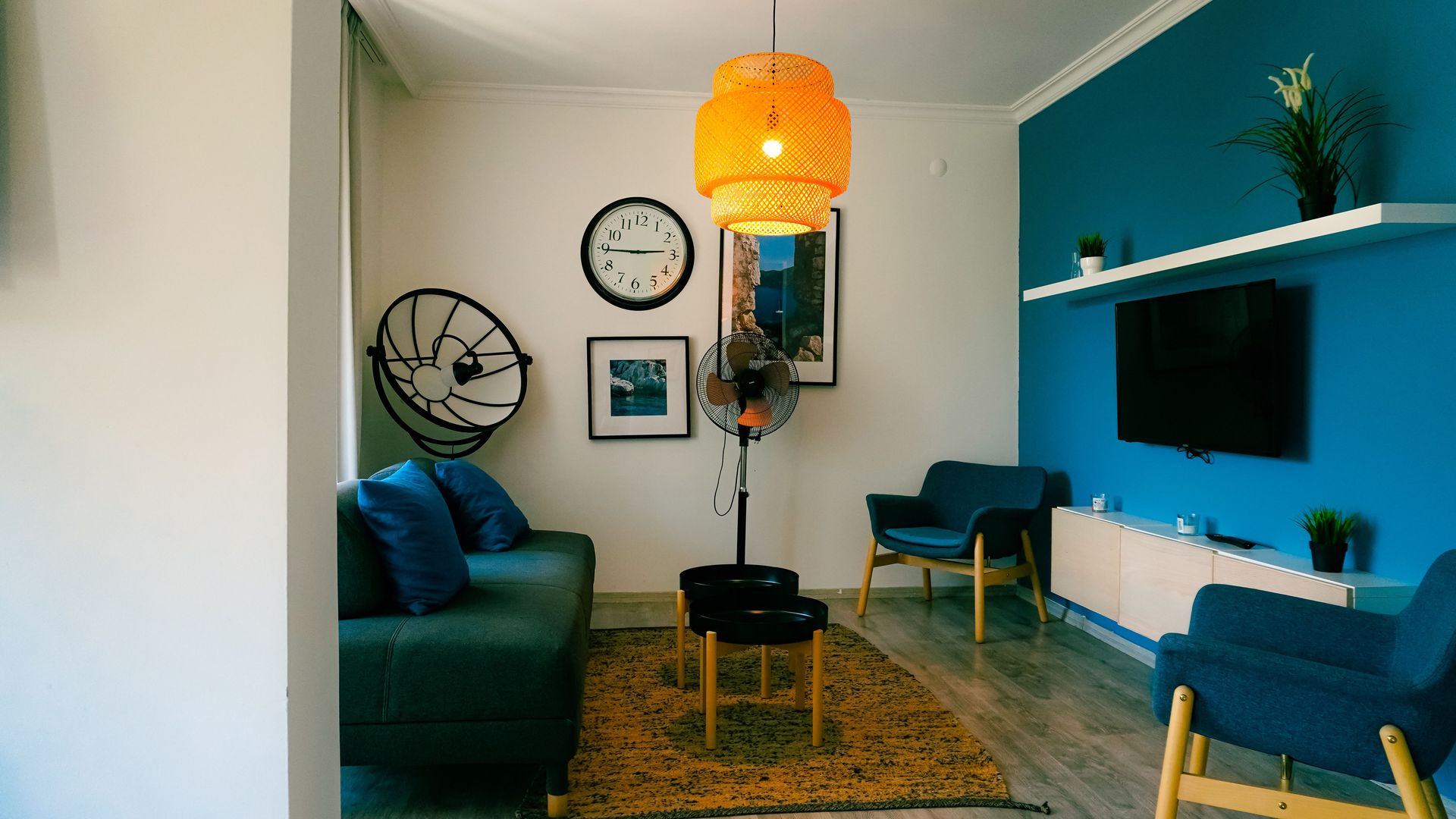 Stylish living room featuring contemporary furniture, blue accents, and a warm ambiance.